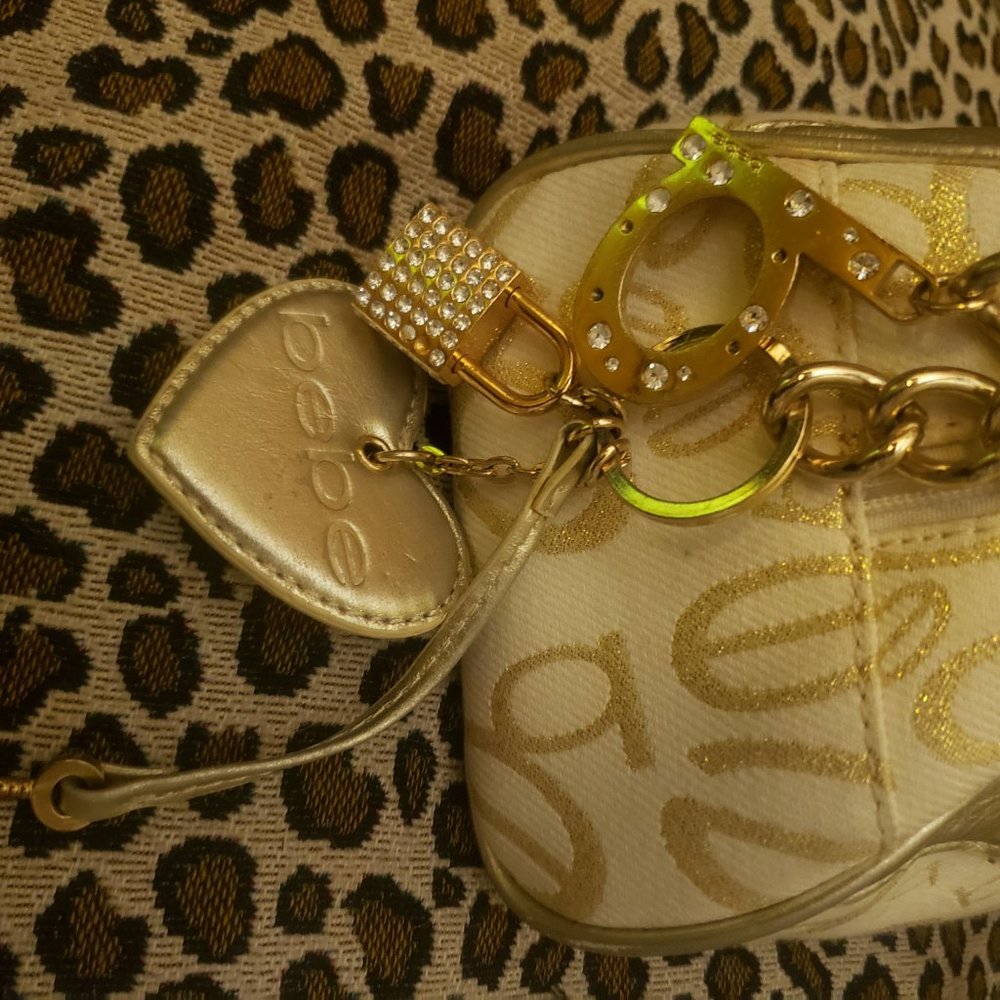 bebe ivory gold shoulder handbag